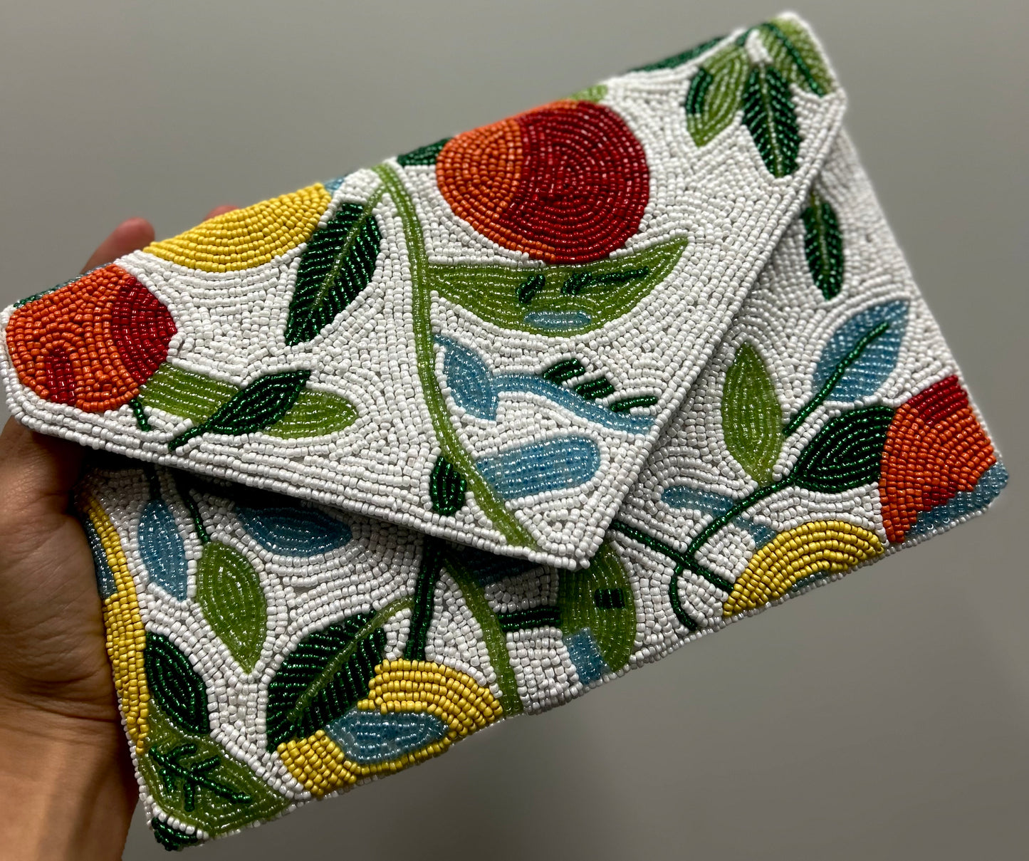 A multicolored clutch bag with a fruit design with beads new zealand