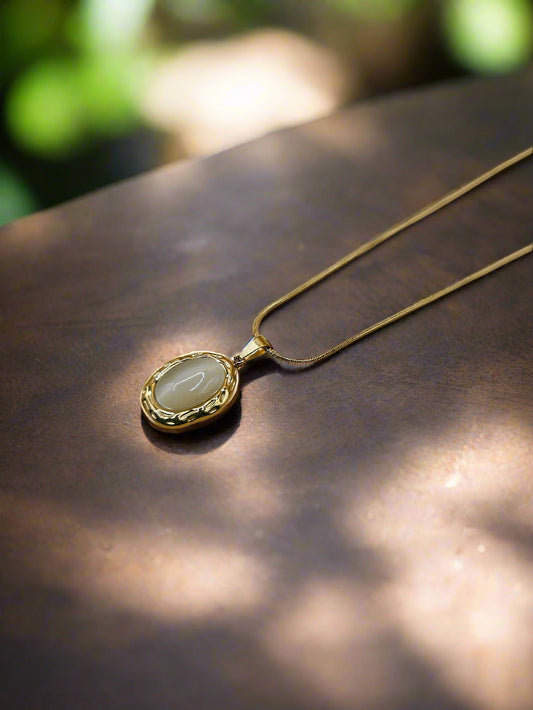 A gold-plated necklace with a round pendant new zealand