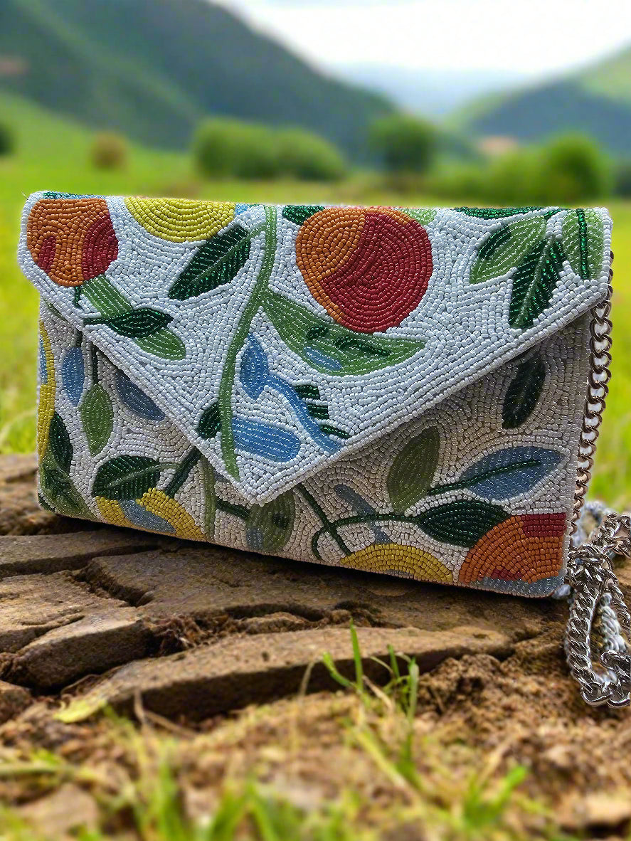 A multicolored clutch bag with a fruit design with beads 