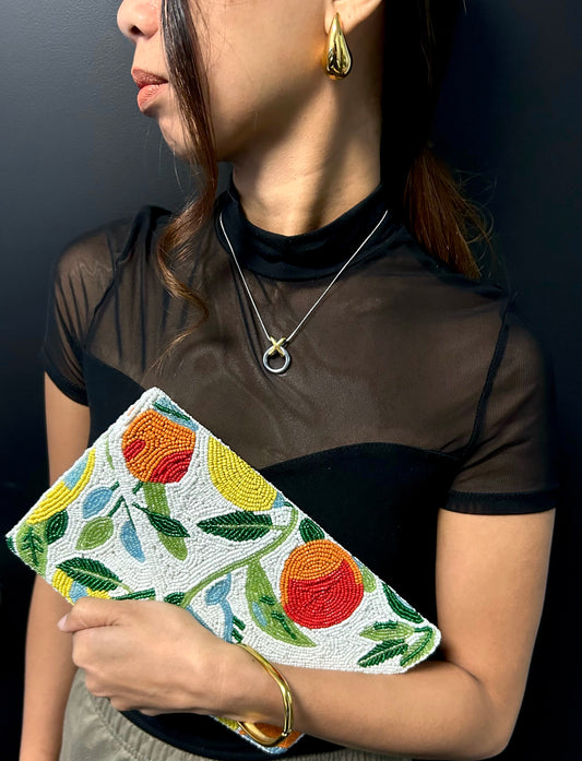 A multicolored clutch bag with a fruit design with beads 