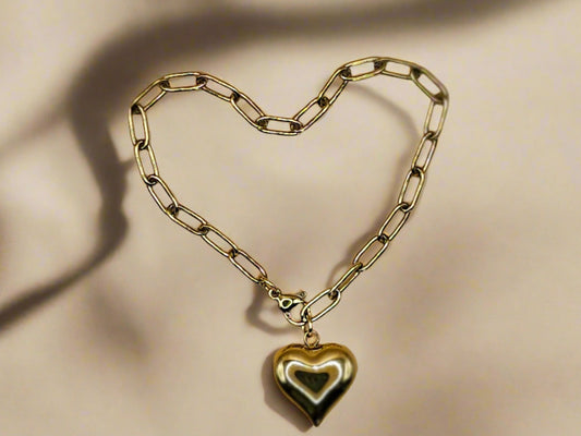 A gold-plated bracelet with a heart-shaped charm